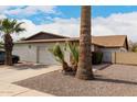 Exterior view of a one story home featuring desert landscaping and a two-car garage at 2524 W Kiva Ave, Mesa, AZ 85202