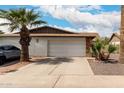 Exterior view of a one story home with a 2-car garage and desert landscaping at 2524 W Kiva Ave, Mesa, AZ 85202