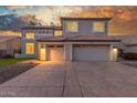 Charming two-story home with a 3-car garage and well-maintained landscaping at dusk at 2754 E Michelle Way, Gilbert, AZ 85234