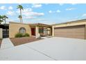 Charming single-story home with desert landscaping, a two-car garage, and a red front door at 3228 W Mercer Ln, Phoenix, AZ 85029