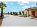 Single-story home with desert landscaping, large driveway, and a red front door at 3228 W Mercer Ln, Phoenix, AZ 85029