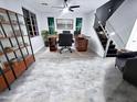 Bright home office featuring gray floors, a ceiling fan, and a sleek wooden desk at 3330 W Gran Paradiso Dr, Phoenix, AZ 85086