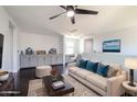 Upstairs living room features plush furniture, ceiling fan, and built-in cabinetry with desk at 3330 W Gran Paradiso Dr, Phoenix, AZ 85086