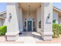 Covered entrance to the home featuring sidelights, sconces, and a hanging lantern at 3544 E Fox St, Mesa, AZ 85213