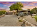 Desert home with mature landscaping and a private driveway leading to the garage at 41590 N 108Th St, Scottsdale, AZ 85262