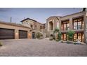 Elegant two-story home featuring a spacious driveway, manicured landscaping, and a three-car garage at 42155 N 97Th Way, Scottsdale, AZ 85262