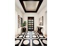 Bright foyer with eye-catching tile flooring, a modern ceiling design, and elegant decor accents at 42155 N 97Th Way, Scottsdale, AZ 85262