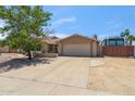 View of home's exterior featuring long driveway leading to a two-car garage at 5319 E Gelding Dr, Scottsdale, AZ 85254