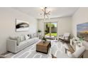 Bright living room features modern chandelier, neutral colors, and access to outdoor space at 5319 E Gelding Dr, Scottsdale, AZ 85254