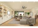 Bright living room boasts modern built-ins, neutral decor, light hardwood flooring and an inviting seating area at 5402 E Michelle Dr, Scottsdale, AZ 85254