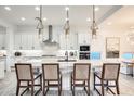 Bright kitchen featuring a center island with seating, stainless steel appliances, and modern pendant lights at 5901 E Sierra Morena St, Mesa, AZ 85215