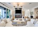 Modern living room featuring a fireplace, TV, luxury furnishings, recessed lighting, and expansive windows at 5901 E Sierra Morena St, Mesa, AZ 85215