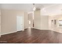 Open living room with hardwood floors, neutral walls, and ample natural light from many windows at 7002 E Exmoor Dr, Mesa, AZ 85208