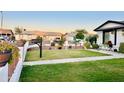 Well-maintained front yard with manicured lawn, decorative landscaping and charming curb appeal at 7943 W Mariposa Dr, Phoenix, AZ 85033