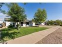 Inviting single-story home with mature trees and a lush green lawn at 819 N Robson --, Mesa, AZ 85201