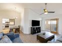 Open-concept living room featuring vaulted ceilings, tile flooring, and modern ceiling fan at 905 E Bluefield Ave, Phoenix, AZ 85022