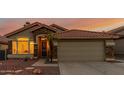 Charming single-Gathering home with a terracotta roof, desert landscaping, and stone accents at 1011 E Amberwood Dr, Phoenix, AZ 85048