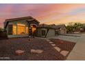 View of the single-Gathering home with a terracotta roof, desert landscaping, and stone accents at 1011 E Amberwood Dr, Phoenix, AZ 85048