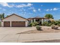 Lovely home with a three car garage, landscaped yard, and a covered porch area for shade and relaxation at 10205 E Corrine Dr, Scottsdale, AZ 85260
