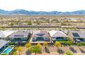 Panoramic aerial view showcasing the property's backyard, neighboring homes, and the mountain landscape at 11575 N 190Th Ln, Surprise, AZ 85388