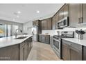 Spacious kitchen featuring a large island, stainless steel appliances, and wood-look flooring at 11575 N 190Th Ln, Surprise, AZ 85388
