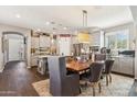 This formal dining area is part of the open-concept kitchen with grey cabinets and stainless steel appliances at 13088 N 91St Dr, Peoria, AZ 85381