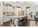 An open kitchen with grey cabinets, granite countertops, an island and stainless steel appliances at 13088 N 91St Dr, Peoria, AZ 85381