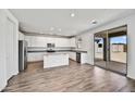 Modern kitchen with granite counters, stainless steel appliances, and a sliding glass door at 13294 W Eagle Feather Rd, Peoria, AZ 85383