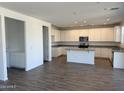 Spacious kitchen featuring an island, stainless steel appliances, white cabinets and granite countertops at 13294 W Eagle Feather Rd, Peoria, AZ 85383