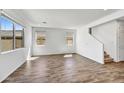 Open living room with hard surface flooring, recessed lighting, and bright light from ample windows at 13294 W Eagle Feather Rd, Peoria, AZ 85383