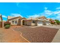 Inviting single-story home featuring desert landscaping, a two-car garage, and a welcoming entryway at 16240 W Maricopa St, Goodyear, AZ 85338