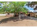 Charming single-story home with a covered carport, mature tree and mixed siding accents at 2308 W Marlette Ave, Phoenix, AZ 85015