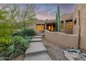 Beautifully landscaped front yard with desert plants and a stone walkway leading to the home at 24644 N 114Th St, Scottsdale, AZ 85255