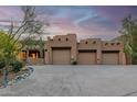 Spacious three-car garage with a circular driveway in a Southwestern-style home at 24644 N 114Th St, Scottsdale, AZ 85255