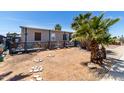 The backyard has a fenced perimeter, mature landscaping, and decorative elements, making it a peaceful outdoor space at 2607 E Phelps Rd, Phoenix, AZ 85032