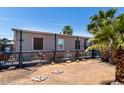 The backyard has a fenced perimeter, mature landscaping, and decorative elements, making it a peaceful outdoor space at 2607 E Phelps Rd, Phoenix, AZ 85032