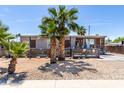 Charming single-story home features a covered porch, fenced yard and mature landscaping, perfect for outdoor living at 2607 E Phelps Rd, Phoenix, AZ 85032