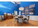 Elegant dining room with high ceilings, a modern chandelier, and striking spiral staircase art at 3108 E San Juan Ave, Phoenix, AZ 85016