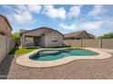 Private backyard featuring a sparkling pool, gravel landscaping, and a covered patio perfect for relaxation at 35709 N Zachary Rd, San Tan Valley, AZ 85144
