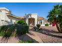 Inviting front entrance framed with desert landscaping and featuring a covered portico at 3740 E Tonto Ct, Phoenix, AZ 85044