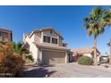A two-story home showcasing desert landscaping and a mature palm tree at 4316 E Bighorn Ave, Phoenix, AZ 85044