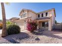 This home has a two car garage and desert landscaping with colorful flowering bushes at 4316 E Bighorn Ave, Phoenix, AZ 85044