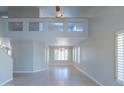Bright and airy living room with high ceilings, tile flooring, and plantation shutters at 4316 E Bighorn Ave, Phoenix, AZ 85044