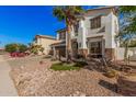 Two-story home with desert landscaping and a palm tree in front at 45247 W Jack Rabbit Trl, Maricopa, AZ 85139