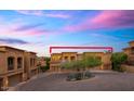 Close exterior view of homes showcases classic architecture with a backdrop of mountains and a colorful sky at 7199 E Ridgeview Pl # 221, Carefree, AZ 85377