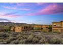 Desert community homes showcase classic architecture against a backdrop of mountains and a colorful sky at 7199 E Ridgeview Pl # 221, Carefree, AZ 85377