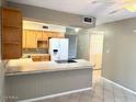 A kitchen featuring a tiled countertop with lots of cabinet space and modern appliances at 814 S 80Th St, Mesa, AZ 85208