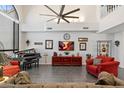 A grand room featuring high ceilings, large windows, tile floors, and comfortable seating at 8879 E Greenview Dr, Gold Canyon, AZ 85118