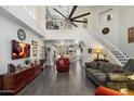 Open living room with staircase, stylish decor, and a view into the kitchen area at 8879 E Greenview Dr, Gold Canyon, AZ 85118
