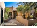 Charming exterior showcases desert landscaping with stucco walls and mature trees at 9154 E Sunflower Ct, Scottsdale, AZ 85266